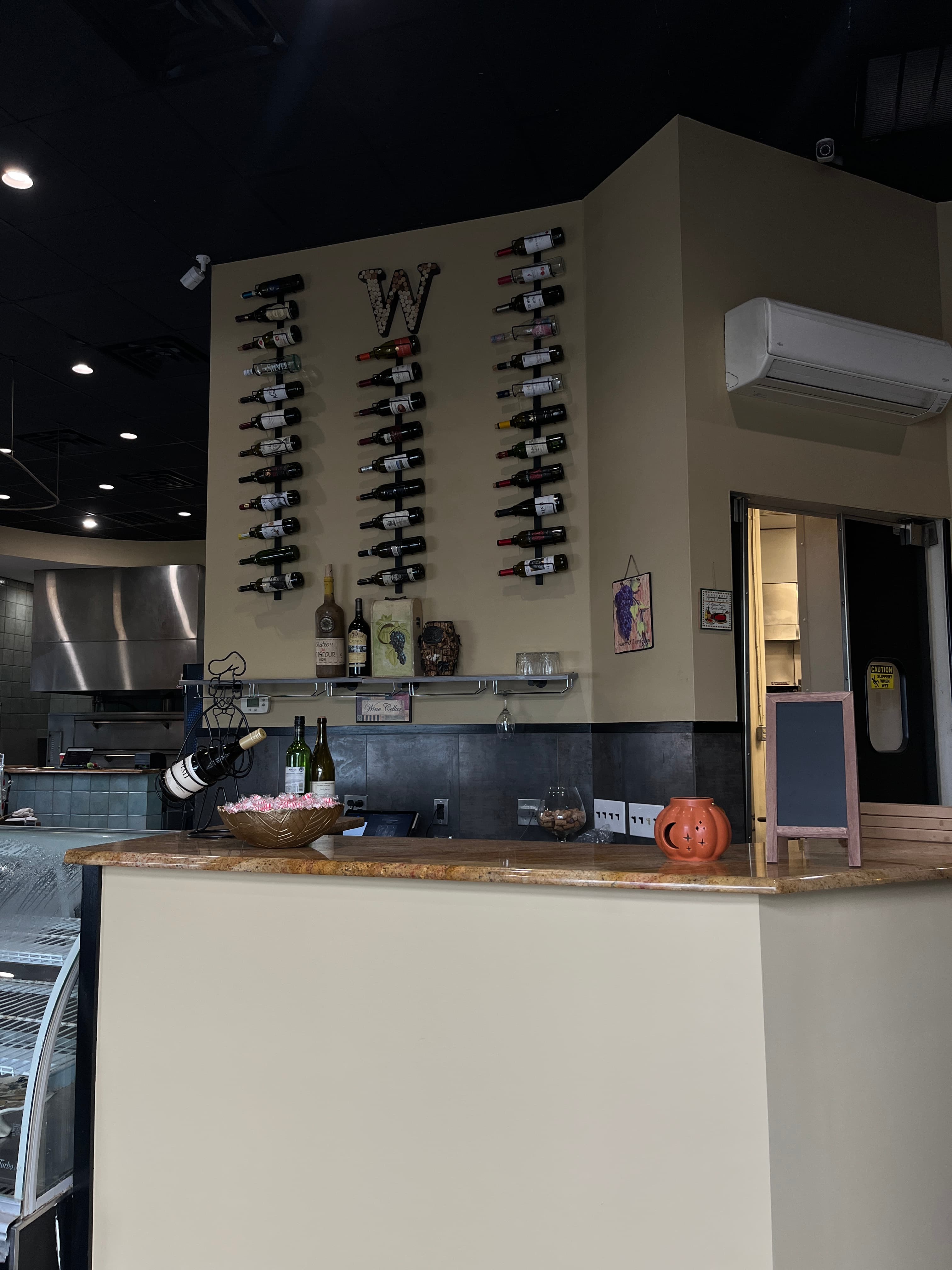 Newly renovated elegant dining room at Mama Mia's Italian Restaurant in Egg Harbor Township NJ with modern pendant lighting and beautiful Italian coastal artwork