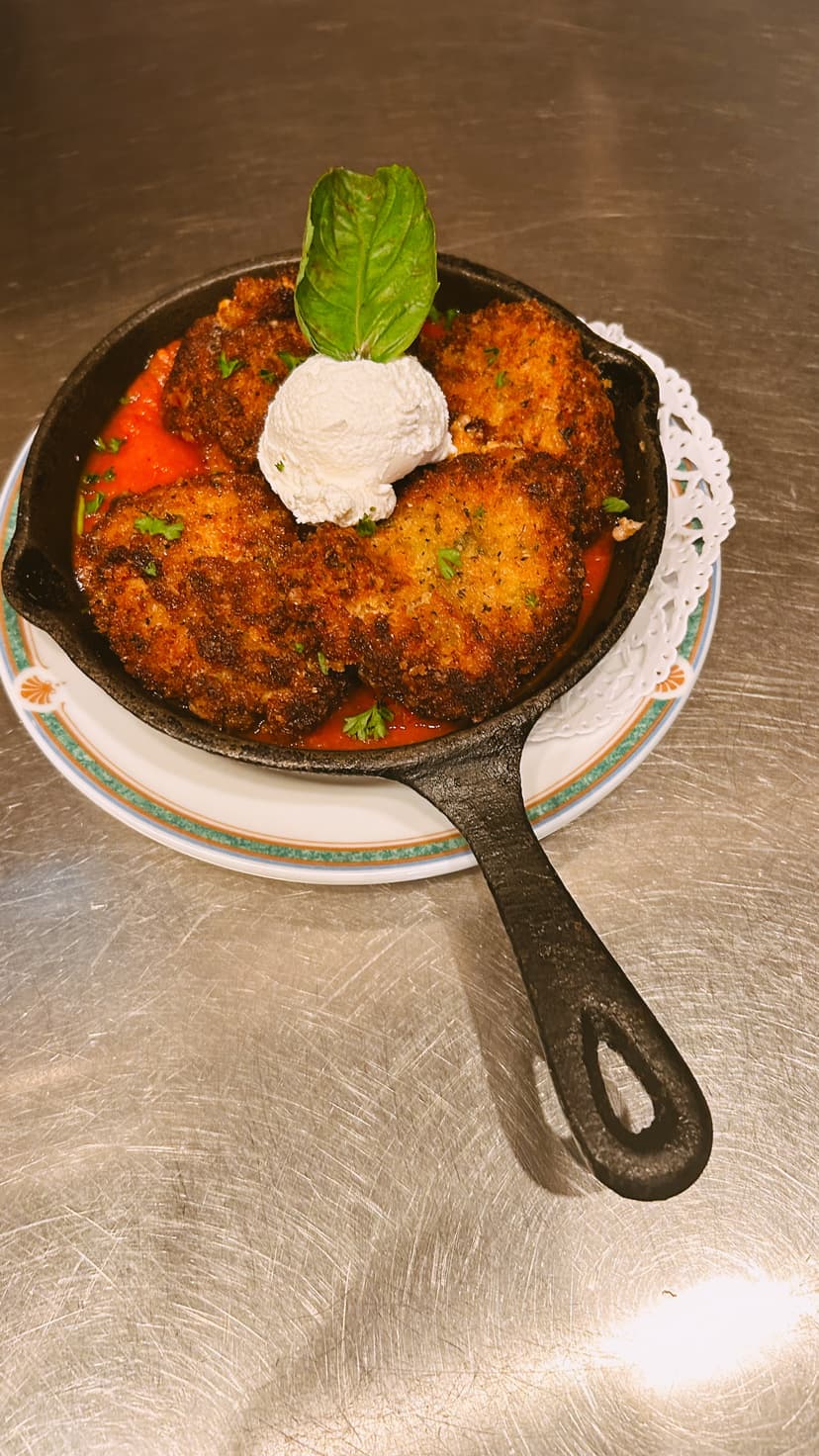 Chef-prepared Italian entree featuring veal and seasonal vegetables at Mama Mia's restaurant