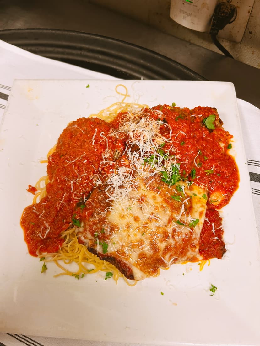 Chef Joseph Massaglia preparing authentic Italian cuisine in Mama Mia's restaurant kitchen